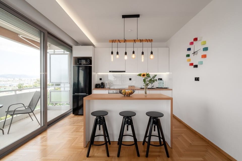 Modern kitchen with island seating and sea views