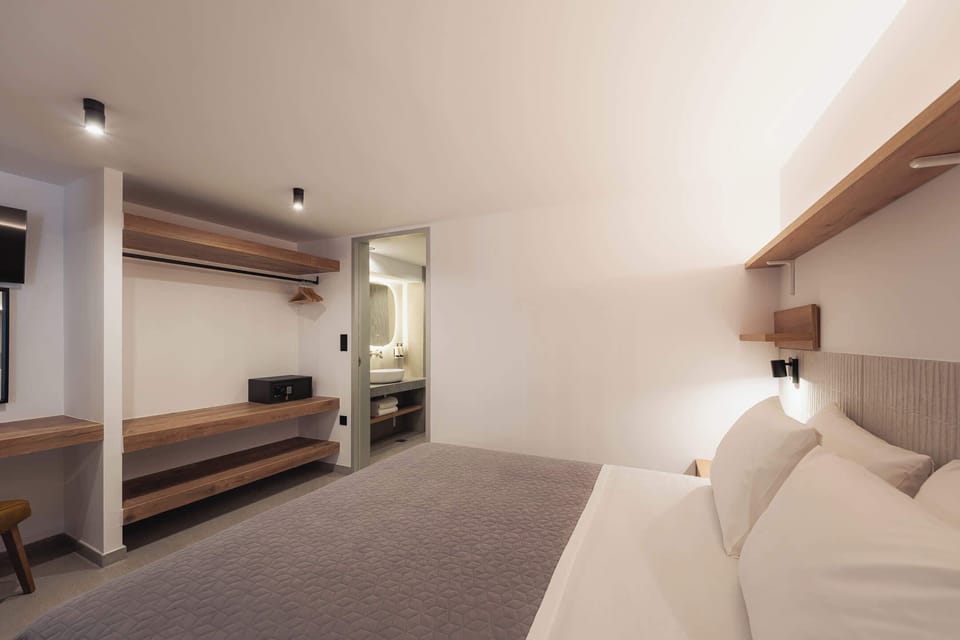 Enjoy the comfort of a bright and spacious bedroom with premium bedding, plenty of storage, and a contemporary design