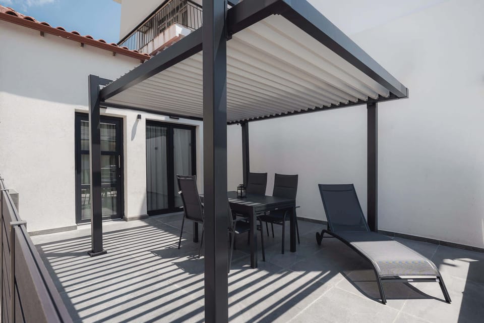 Start your morning with coffee or end your evening with a glass of wine on the private covered veranda. With comfortable outdoor seating and plenty of shade, it's the perfect spot to enjoy the Mediterranean breeze
