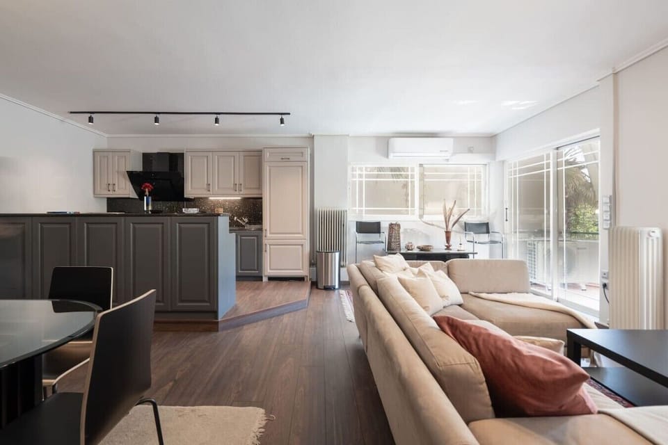 Seamless flow from living room to kitchen island — the kind of open layout that makes longer stays feel like home. Booking.com tag: Living room
