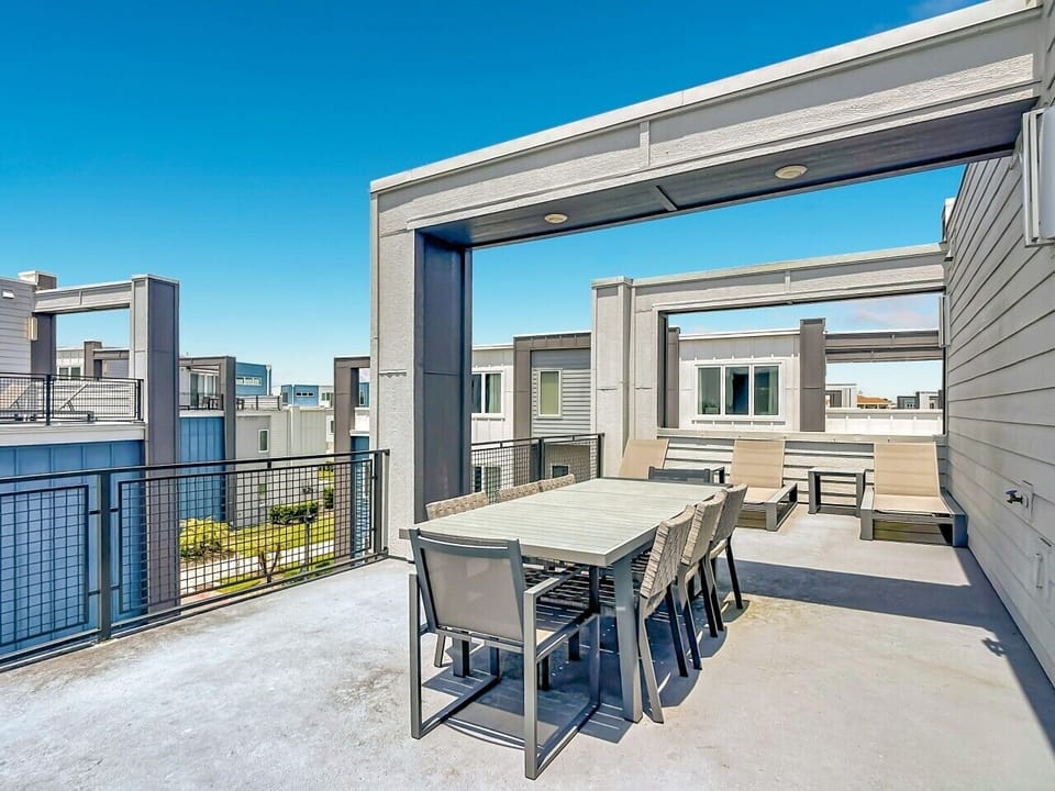 Private balcony with outdoor dining and lounge seating