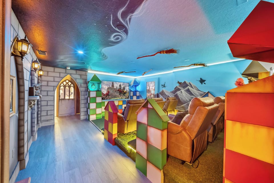 Discover a whimsical play area filled with vibrant structures and charming castle-inspired decor. The painted ceiling enhances the fun, inviting everyone to dive into this colorful adventure.