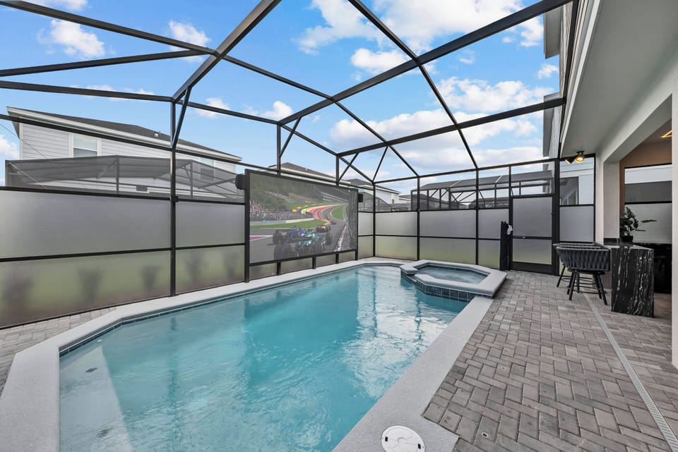 Step outside to your private oasis with a sparkling pool and stylish paver deck. The screened enclosure offers comfort and safety, while the inviting spa is perfect for relaxing under the blue sky. Enjoy leisurely afternoons here.