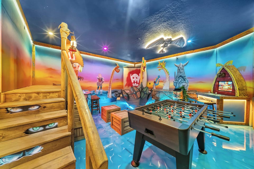 Experience our vibrant pirate-themed game room with colorful murals and whimsical decor. Join in on friendly competition at the foosball table, surrounded by unique furnishings that inspire joy and creativity.