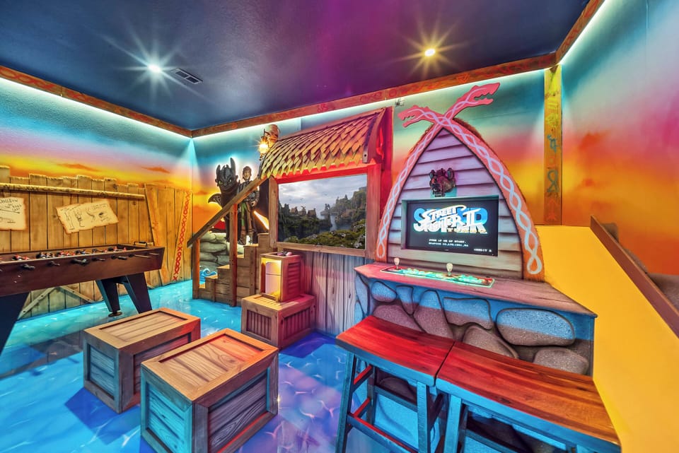 Enjoy a vibrant game room adorned with colorful murals and playful decor that sparks joy. Unique wooden crate seating adds rustic charm, creating a cozy space ideal for laughter and friendly competition with friends.