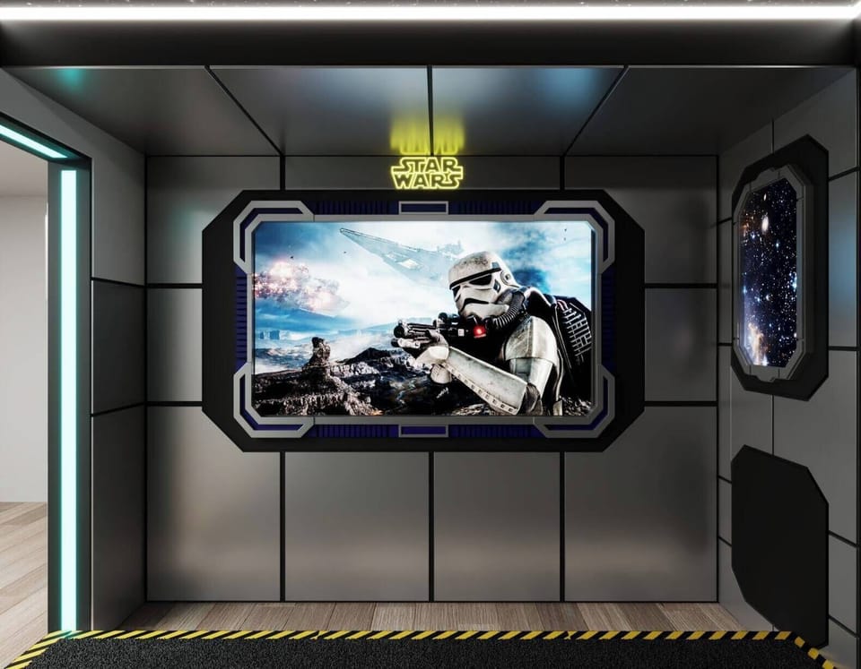 Step into this unique themed space featuring sleek metallic walls and a stunning mural that transports you to a galaxy far away. The ambient lighting sets a playful mood, perfect for unwinding after a day of adventure.