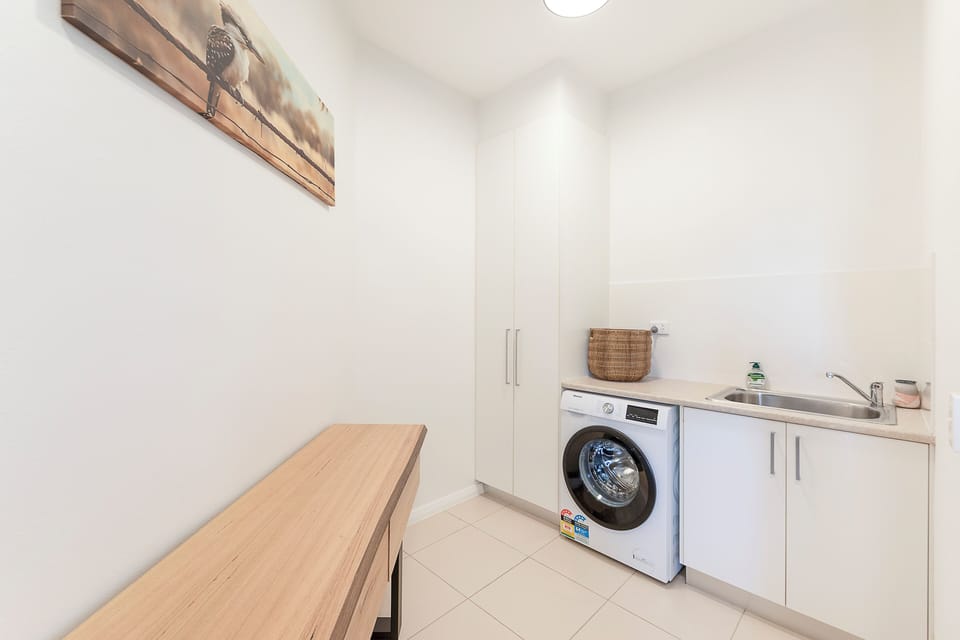 Freshen up your wardrobe in the private laundry, complete with a washer-dryer combo and practical storage to make longer stays feel effortless.