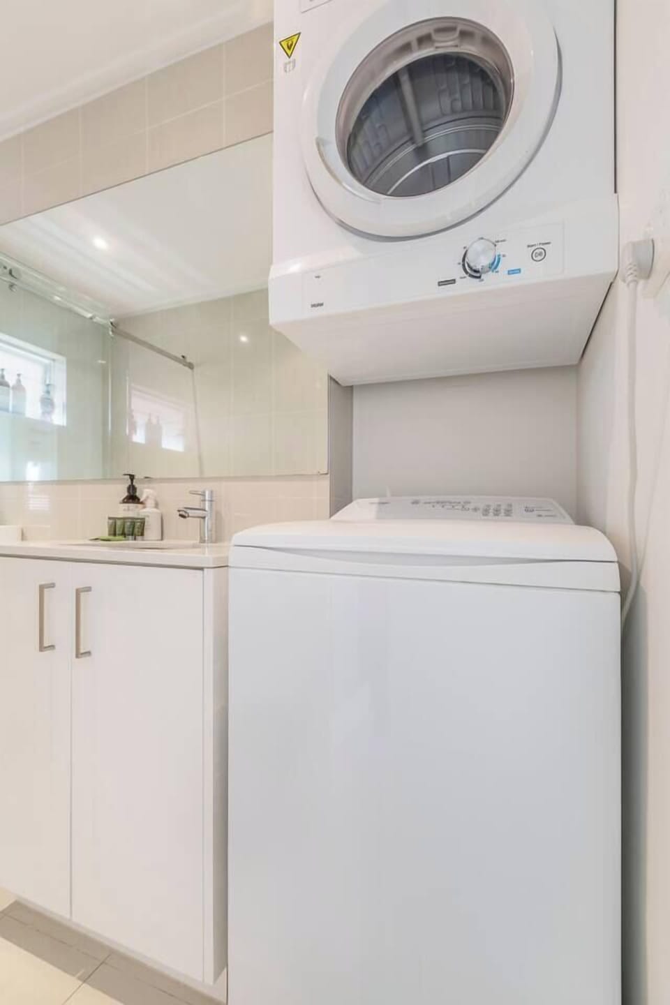 Maintain your laundry routine with a washer and dryer tucked into the bathroom.