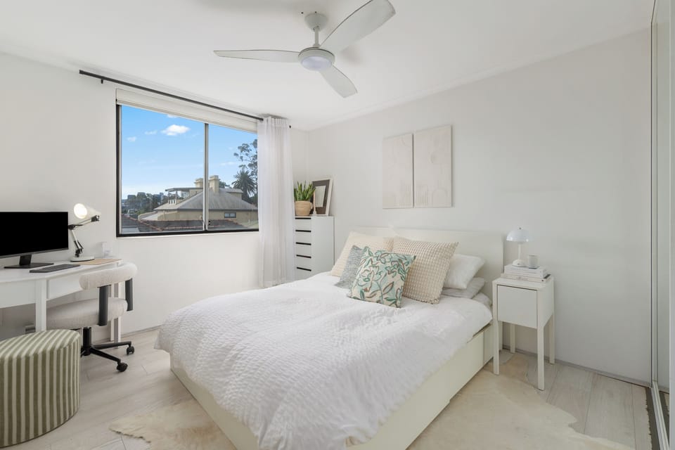 Retreat to the bedroom, where a queen bed, dedicated workspace, and a calm, uncluttered design create an inviting space to recharge.