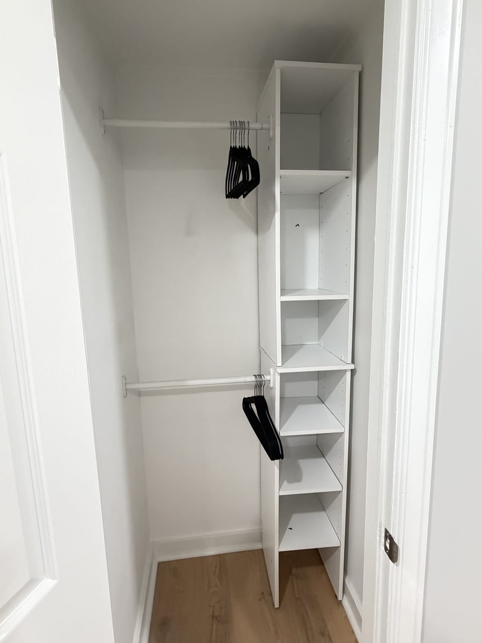 Spacious built-in closet with shelves, cubbies, and double hanging space