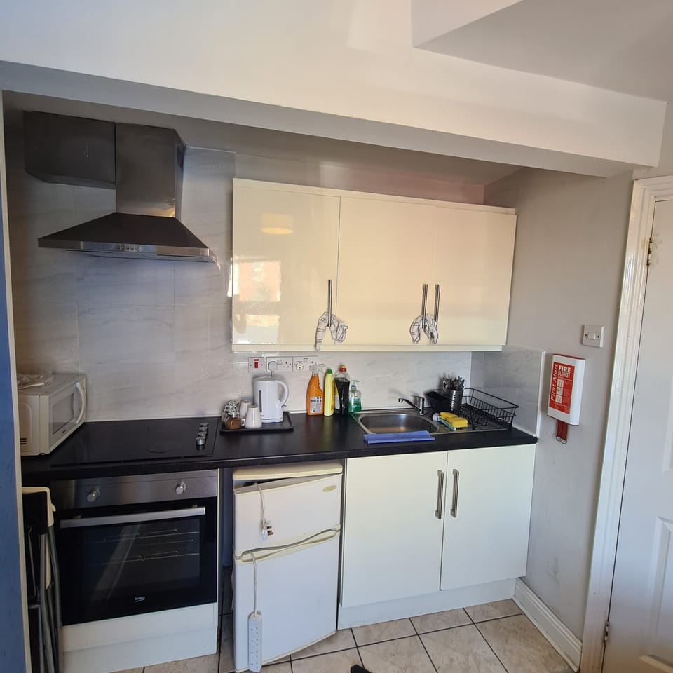Bright, well-equipped kitchen with modern appliances and sleek cabinetry