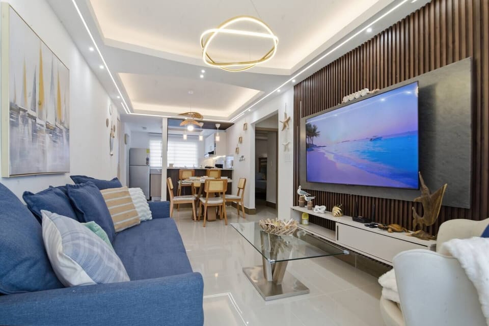 Step into a beautifully designed, open-concept living space crafted for relaxation and style. This contemporary home perfectly balances warm textures with high-end tech, making it the ideal retreat for your next getaway.