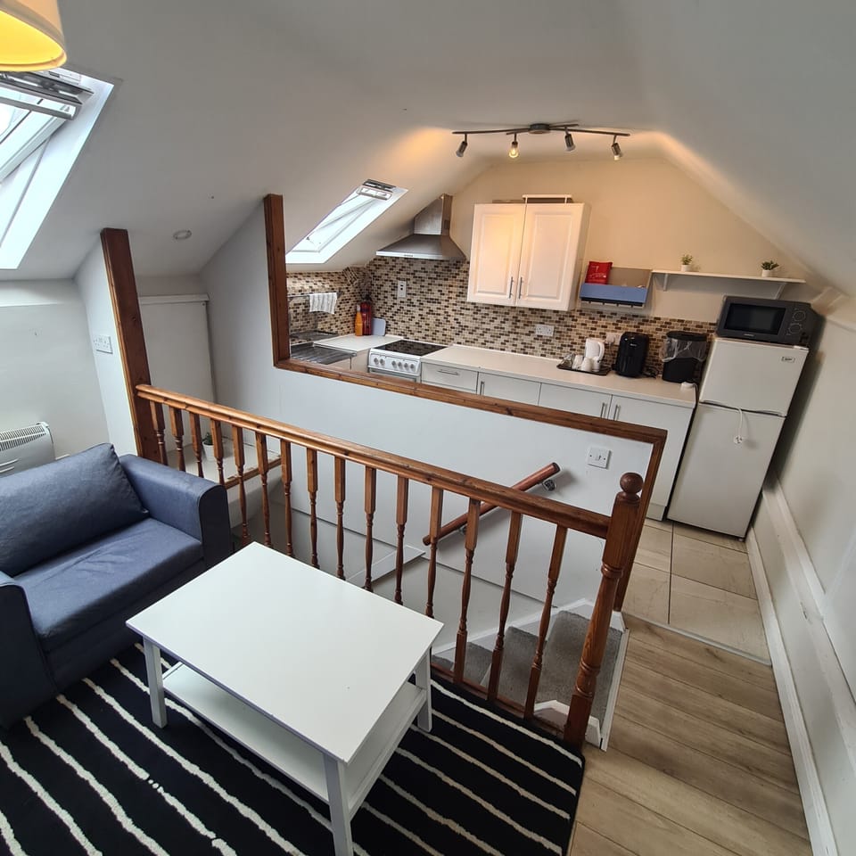 Cozy loft-style suite with open kitchen and bright, inviting living area