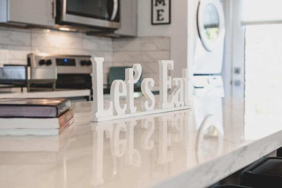 Spacious kitchen island provides additional prep and dining space for everything from quick breakfasts to home-cooked meals.