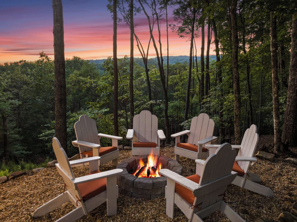 Sunset forest fire pit with Adirondack seating and scenic views
