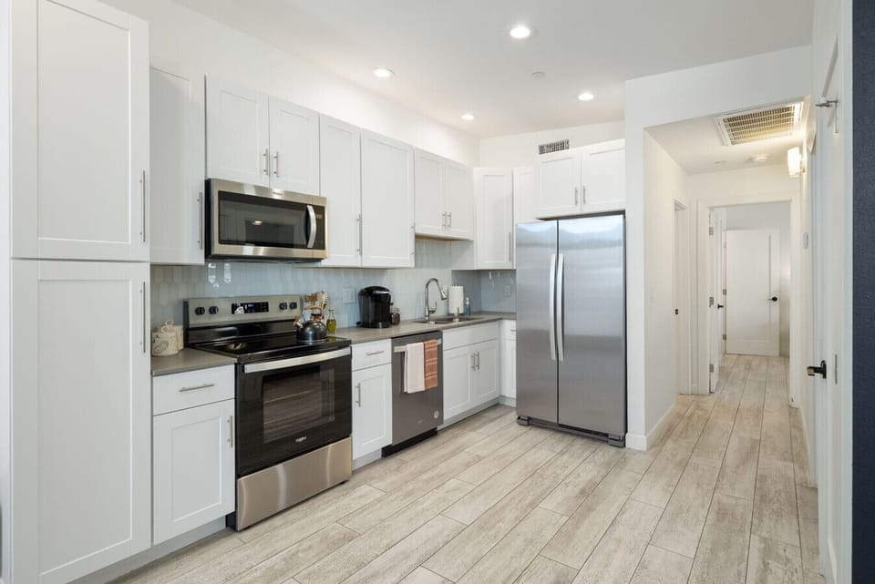 Enjoy a modern kitchen featuring quartz countertops, stainless steel appliances, and a fresh contemporary feel.