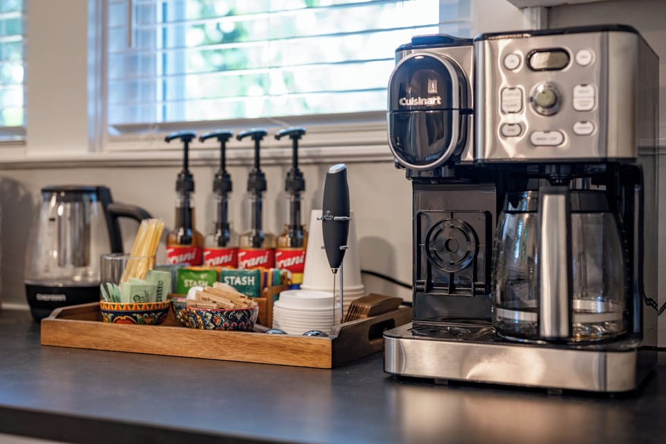 Thoughtful coffee & tea station with brewer, kettle, and guest-ready extras