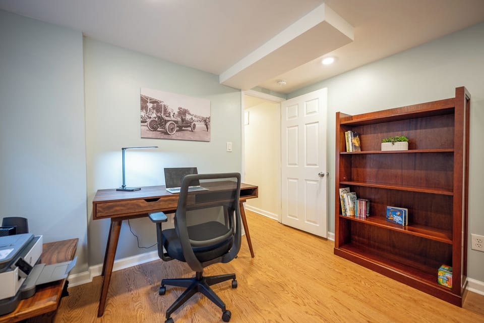 Dedicated home office with stylish desk, ergonomic chair, and bookshelf