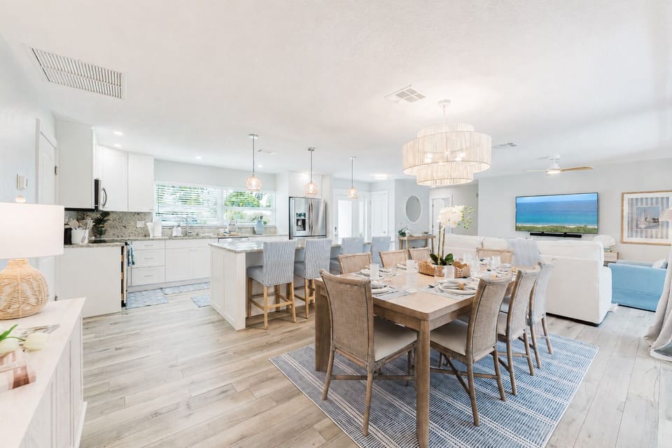 Share unforgettable meals around the spacious dining table with seating for eight, while the oversized kitchen island provides seating for four more. Whether it's a family dinner, holiday celebration, or casual brunch, this bright, coastal-inspired space.