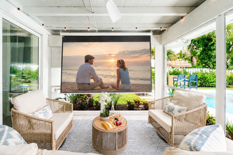 The ultimate indoor-outdoor entertainment space features a fully screened lanai with a lounge area, convertible dining table, and seamless access to the pool and main living spaces.