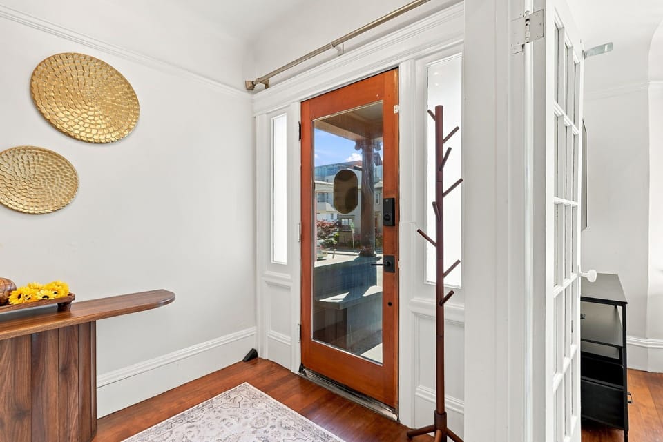 Bright, stylish entryway with natural light and elegant details