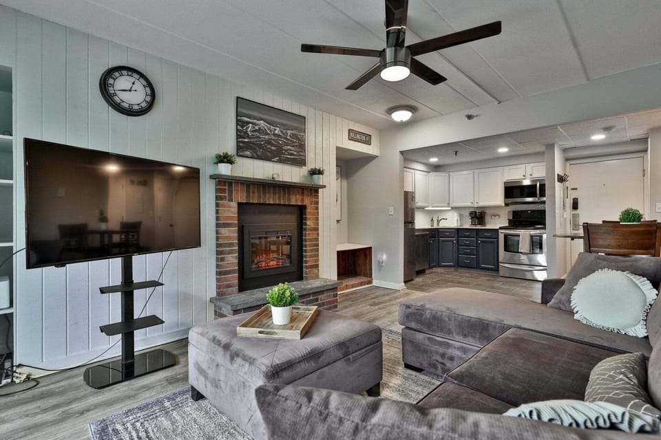 The TV and brick fireplace share the same sightline, so everyone gets a good seat.