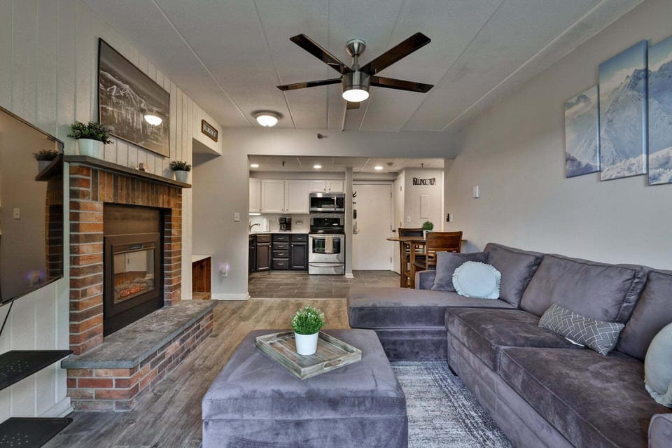 Kitchen, dining, sofa, and balcony flow together in a compact layout built for time together.