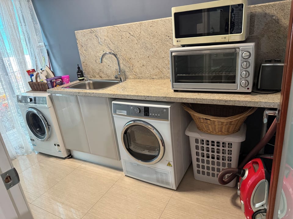 full laundry sink ironing board clothes baskets dryer and washer fisher and pike