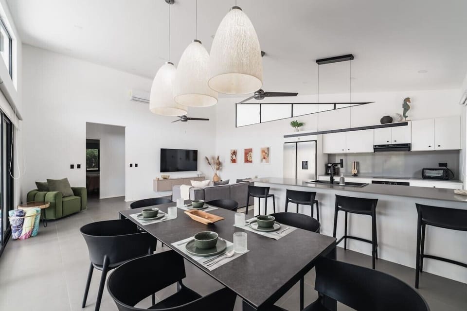 Those three statement pendant lights say it all. A beautifully designed dining space that flows seamlessly into the kitchen and living area, bright, modern, and made for memorable meals together.