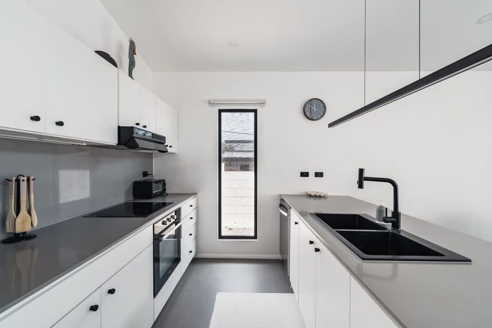 A sleek, fully equipped modern kitchen designed for those who love to cook. Clean lines, quality appliances, and plenty of counter space make meal prep as enjoyable as dining al fresco by the pool.