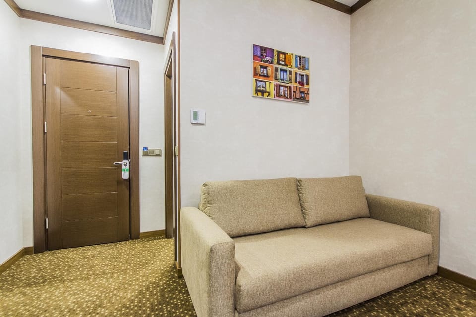 Deluxe Triple Room, Balcony | Living area | TV