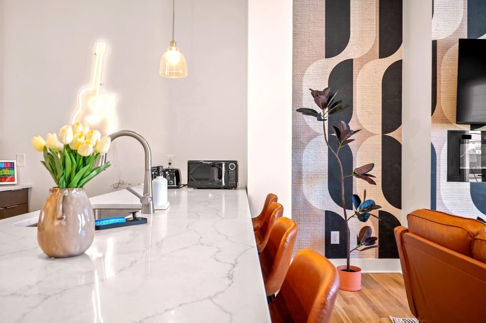 The oversized island keeps everyone connected, whether you're serving breakfast before heading downtown or gathering for late-night bites after the show.
