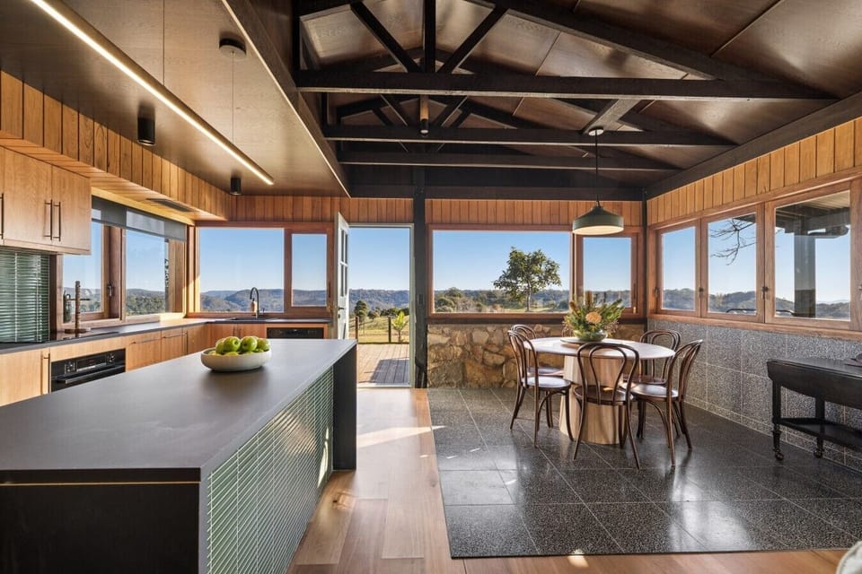 Open plan kitchen and dining with balcony access to outdoor dining area