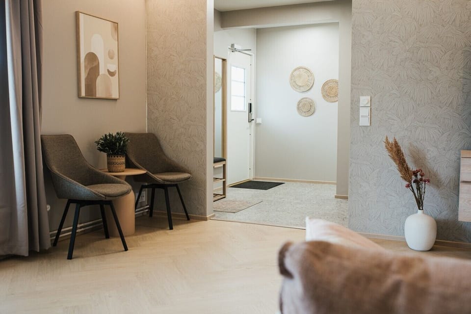 A stylish hallway nook with seating and a mirror right by the entrance.