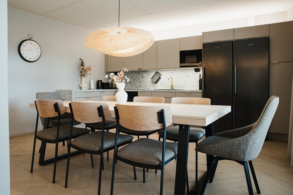 The open kitchen and dining area comes with a large table and seating, perfect for cooking and gathering together.