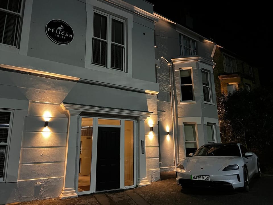 Pelican House: elegant lit facade, bay windows, and off‑street Paid parking