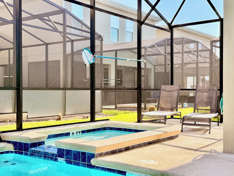 Relax on the pool deck with spa, loungers & full mesh screening.