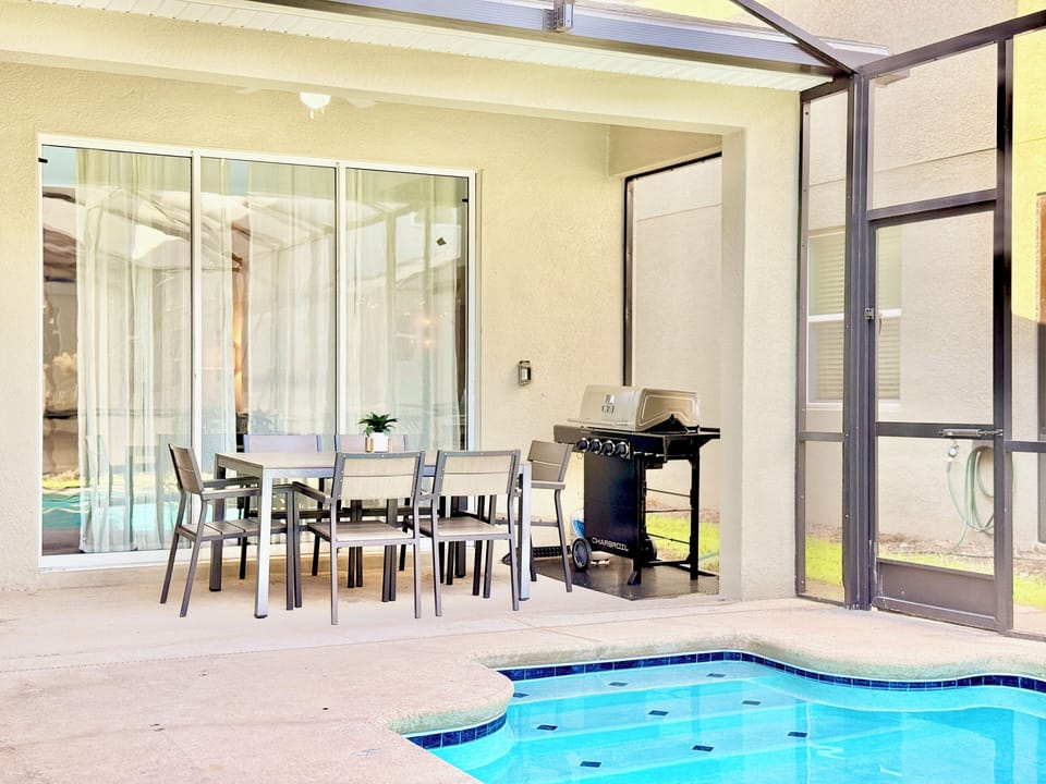 Dine by the pool with a covered lanai, dining table for six & gas BBQ grill.


