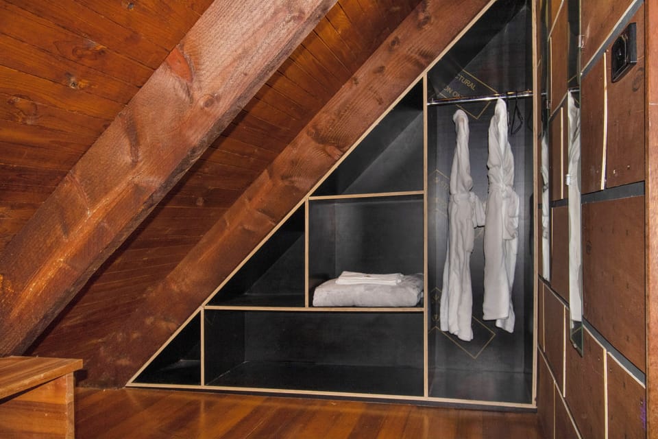Custom attic wardrobe with robes and smart built-in storage