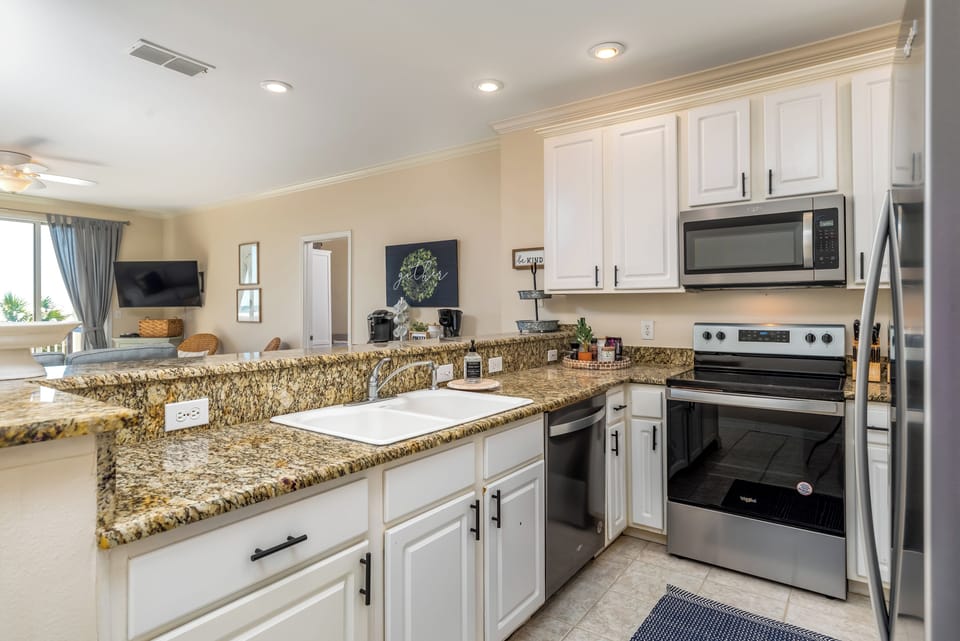 Your spacious kitchen features granite countertops, stainless steel appliances, and everything you need to create memorable meals during your stay.