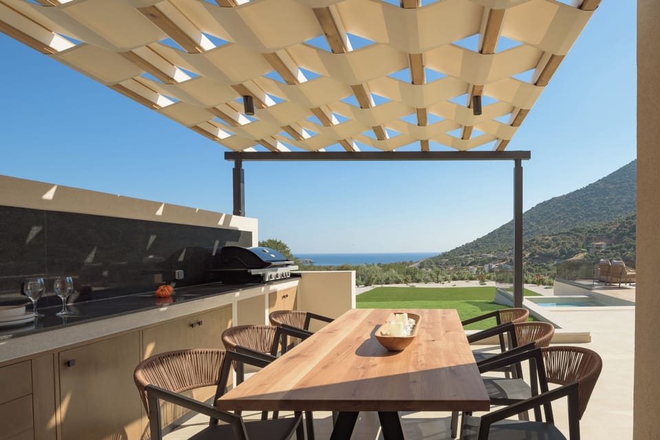 The gas barbecue makes summer cooking simple beside the pool terrace.