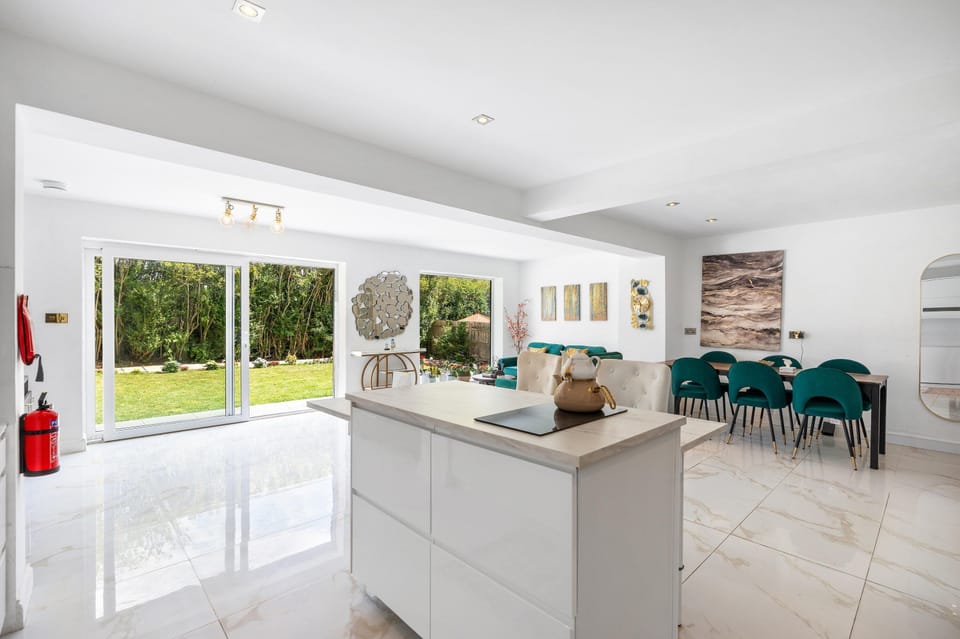 Bright open-plan kitchen and lounge combining modern appliances, cosy seating and plenty of space to socialise.