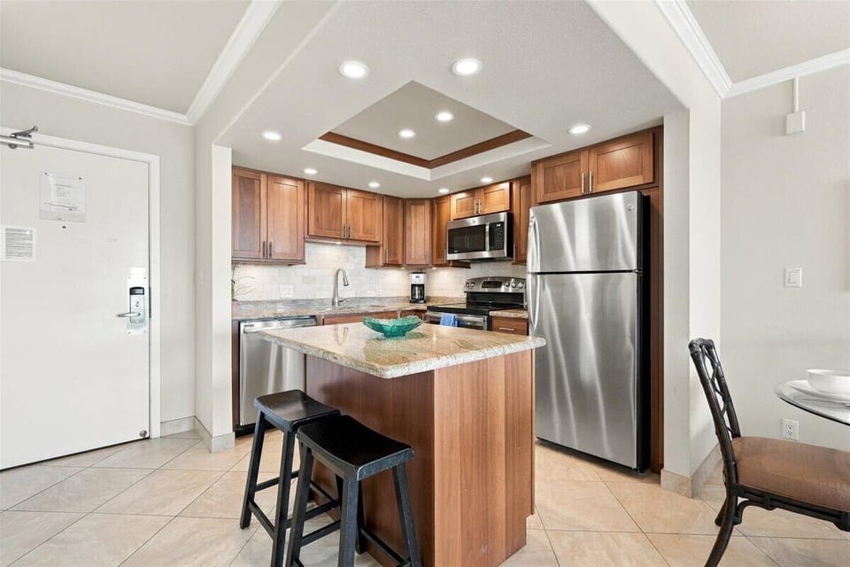 Your fully equipped kitchen features stainless steel appliances. The center island offers a perfect spot for morning coffee or casual dining.