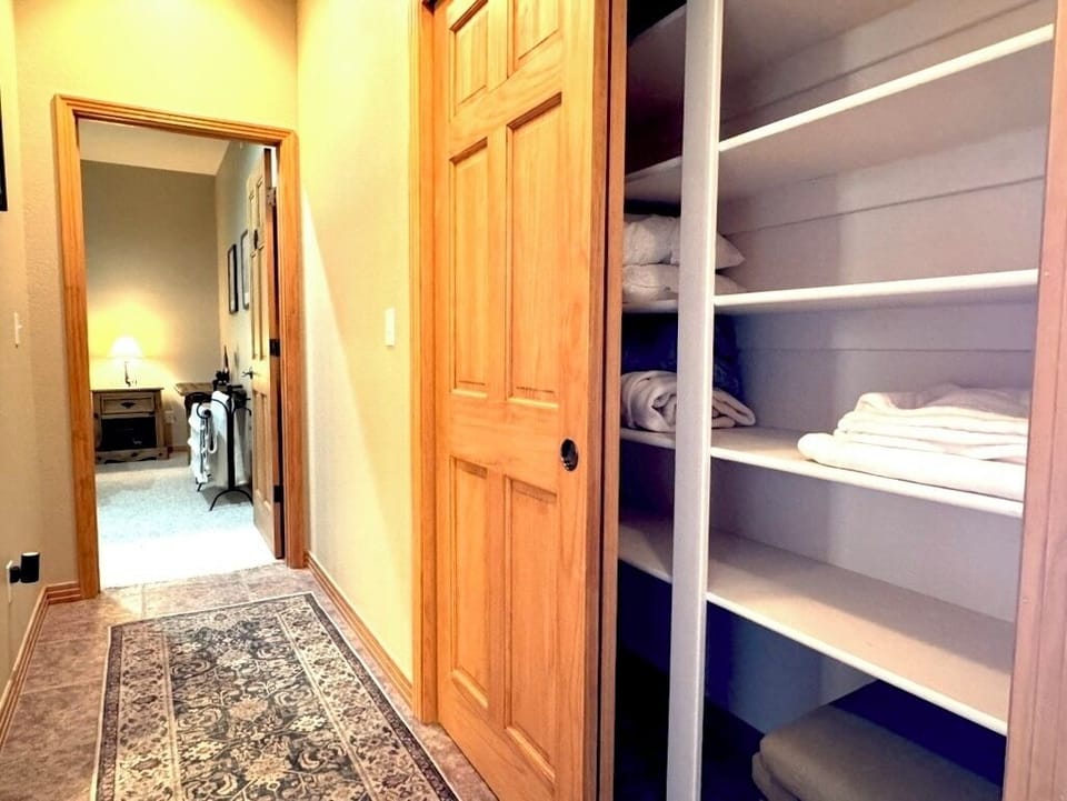 Hallway closet includes extra towels and extra storage space that can be used during the stay.