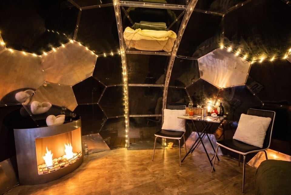 Wind down by the fire with blankets and candlelit charm