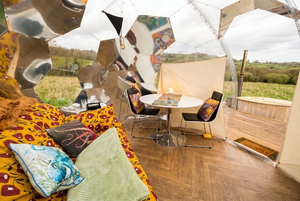 Cosy dome interior opening onto rolling countryside views