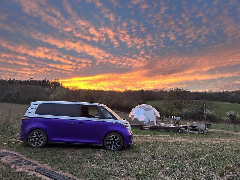 Golden sunrise skies over the dome, camper van optional adventure