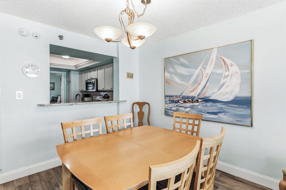 Gather around the welcoming dining table where your group can share meals and stories. The open kitchen pass-through makes serving and conversation effortless, while the soft lighting creates a cozy atmosphere for memorable dinners together.
