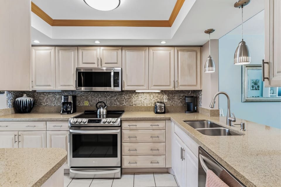Step into this bright, well-equipped kitchen where you'll find everything needed to whip up your favorite meals. Modern appliances and ample counter space make cooking a pleasure during your stay.