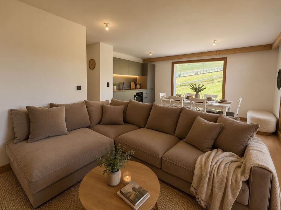 The open-plan living area brings everyone together, with views of the pistes from the sofa and dining table.